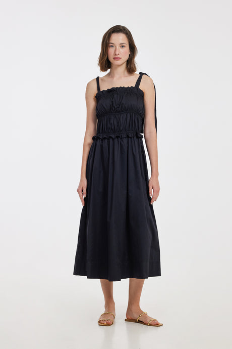 Black midi dress with a smocked bodice and thin adjustable shoulder straps.