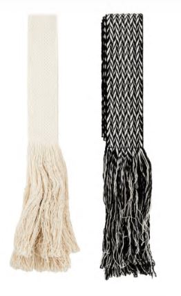 Black and off-white woven belt with fringed ends and chevron pattern.