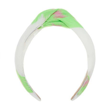 Knotted fabric hairband in green and fuchsia with a soft white base and floral pattern.