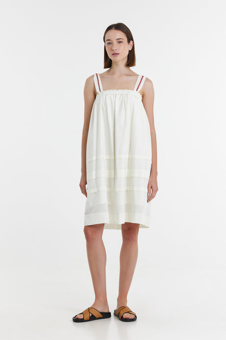 Off-white sleeveless short summer dress with square neckline and double shoulder straps.