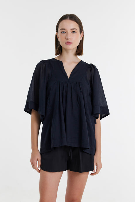 Black loose-fit blouse with short wide sleeves and V-neck on female model.