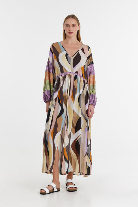 Long jacquard dress with flowing multicolor abstract waves and balloon sleeves.