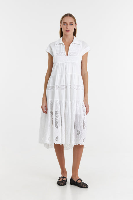 White lace midi dress with cap sleeves and a v-neck collar, fitted bodice, and flowing skirt.