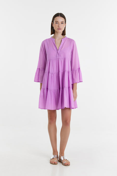 Lavender short dress with tiered skirt and three-quarter bell sleeves on model.