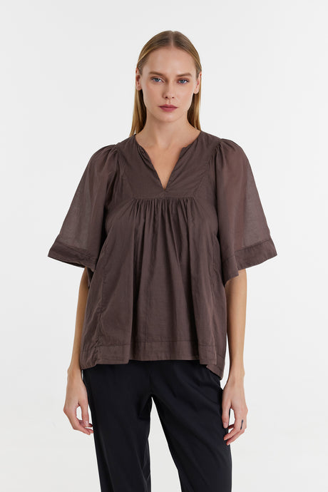 Brown loose-fit blouse with short puff sleeves and gathered V-neck detail.