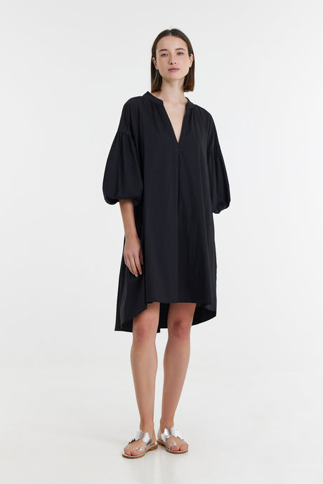 Black midi dress with voluminous three-quarter sleeves and a deep V-neckline.