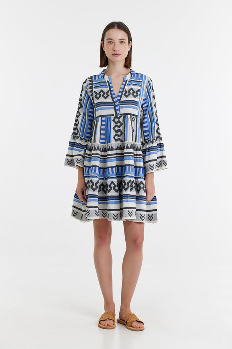 Blue and black jacquard long-sleeve dress with geometric and floral patterns, tiered skirt, and V-neckline.