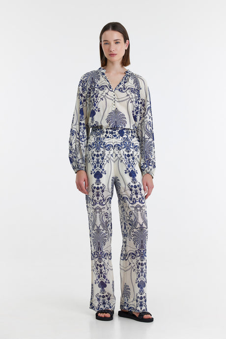 Blue and white floral print long-sleeve blouse and matching flared pants set.
