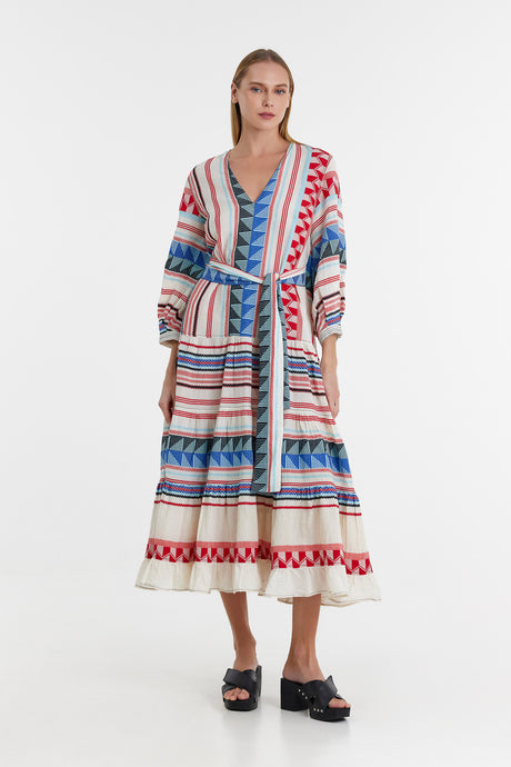 Long jacquard dress in blue, red, and white with belted waist and V-neckline.