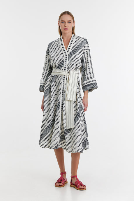 Black and off-white jacquard long dress with diagonal stripes and a wrap tie belt.