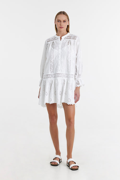 White lace long-sleeve short dress with ruffled hem and intricate embroidered details.