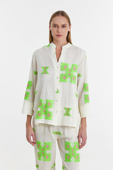 White jacquard blouse with bright green geometric patterns and a relaxed fit.
