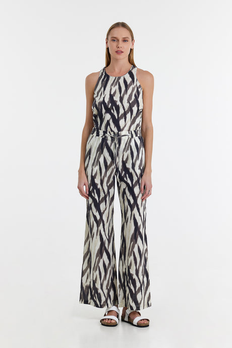 Black and white abstract print wide-leg pants with matching sleeveless top and black sandals.