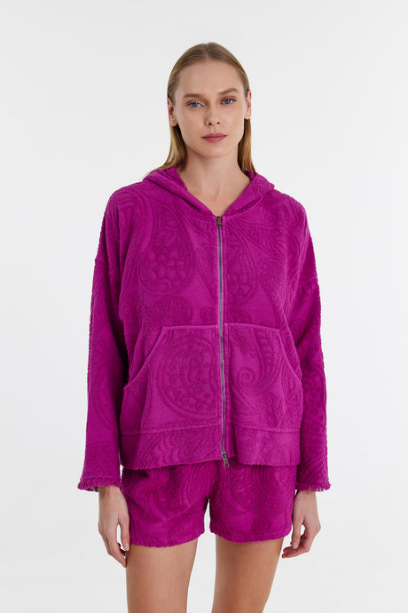 Magenta hooded zip-up jacket with large front pockets and relaxed fit on female model.