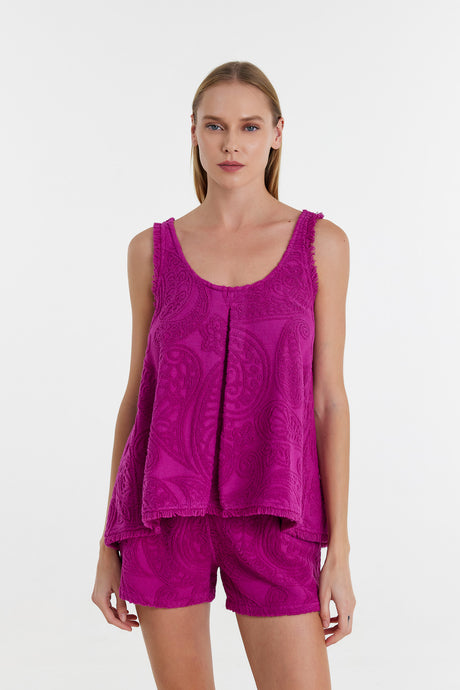 Magenta sleeveless blouse with scoop neck and textured fabric, paired with matching shorts.