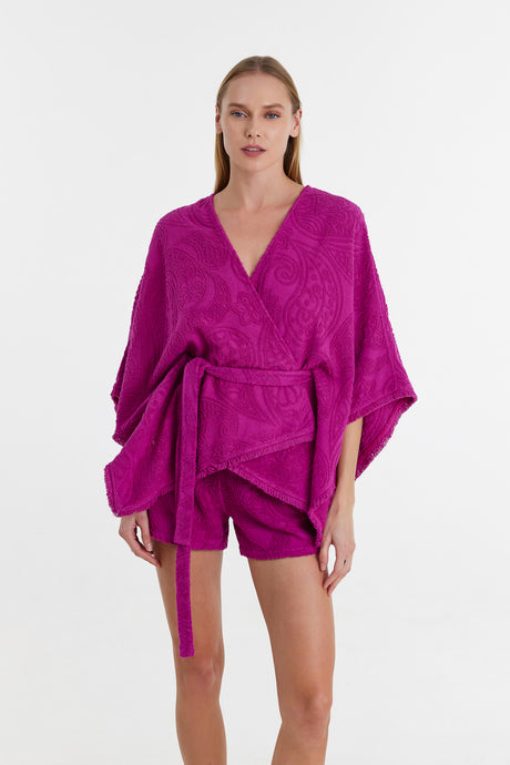 Magenta kimono-style blouse with wide sleeves and waist tie, paired with matching shorts.