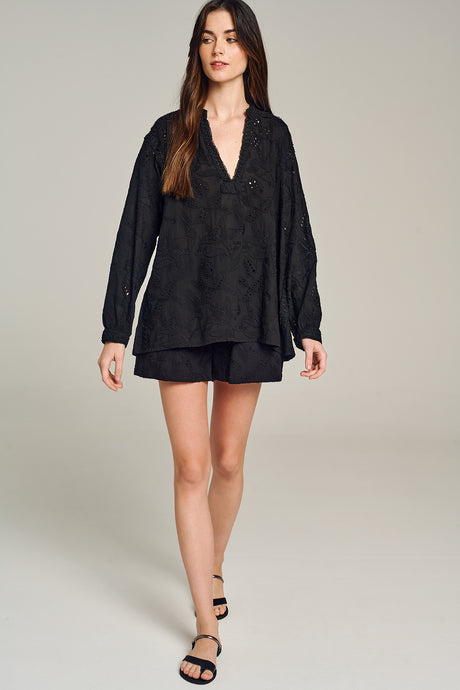 Black long-sleeve blouse with subtle floral embroidery and a relaxed fit collar.