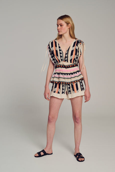 Sleeveless multicolor jacquard top with deep V-neck and fringed hem paired with matching shorts.