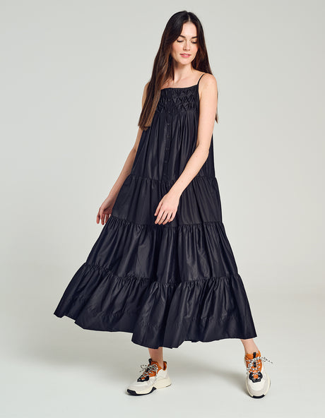 Black long tiered popeline dress with spaghetti straps and a flowy silhouette.
