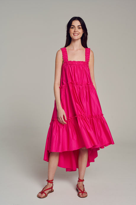 Pink sleeveless midi dress with square neckline and tiered skirt, styled with red sandals.