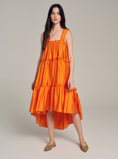 Orange sleeveless midi dress with tiered ruffles and square neckline.
