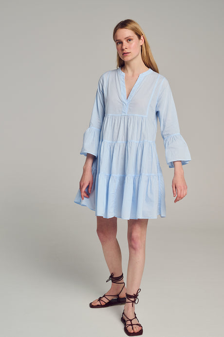 Light blue short dress with tiered skirt and three-quarter bell sleeves.