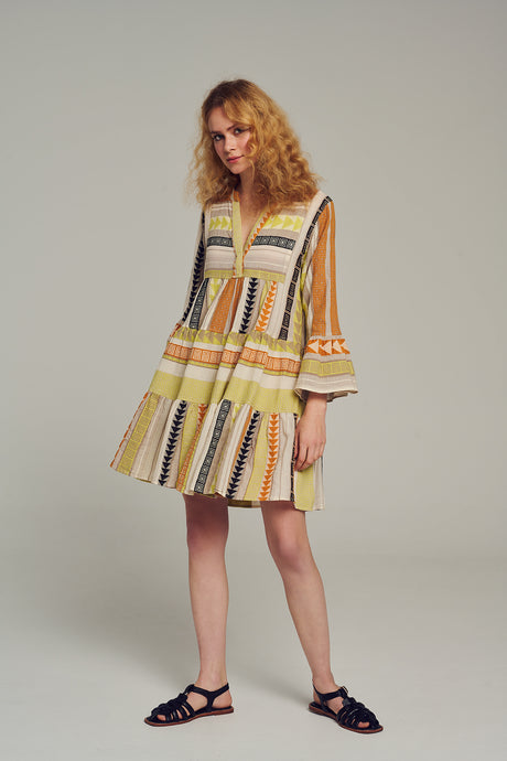 Knee-length dress with multi-color jacquard pattern in lime, black, and yellow tones, flared sleeves, and V-neckline.