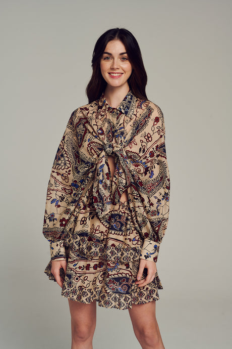 Multicolored printed skirt with paisley and floral patterns worn high-waisted in a flowy design.