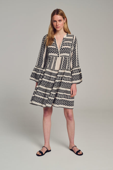 Black and off-white jacquard short dress with long puffed sleeves and tiered skirt.