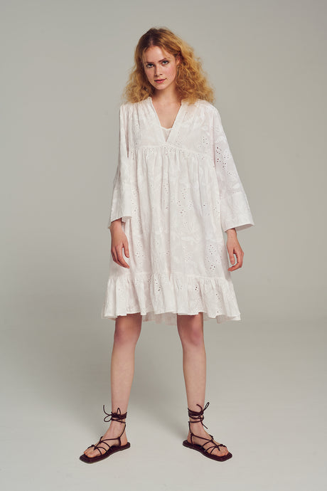 White knee-length dress with loose fit, long sleeves, v-neck, and subtle embroidery lace details.