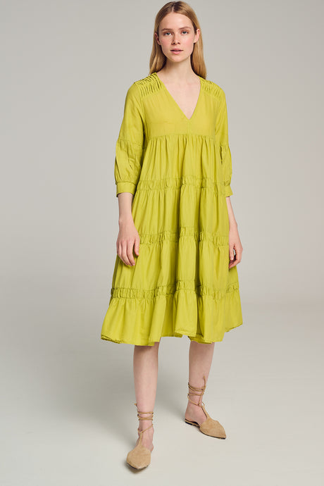 Green midi dress with deep V-neck, tiered skirt, and 3/4 sleeves on a model.