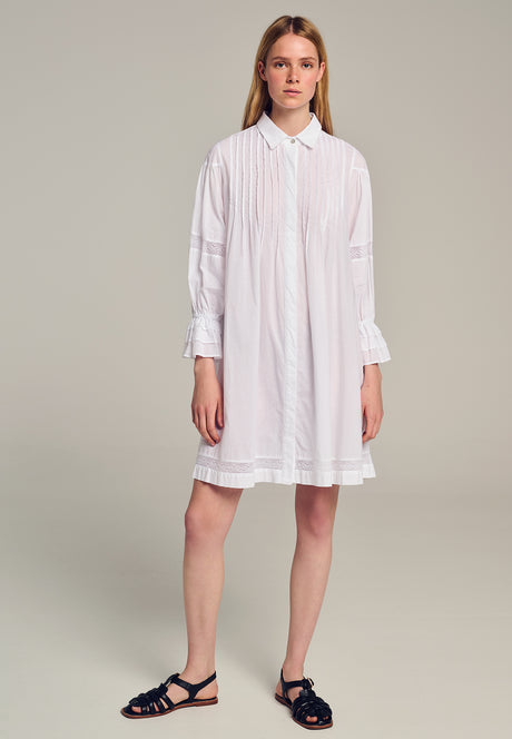 White long-sleeve shirt dress with front buttons and relaxed fit, knee-length hem.