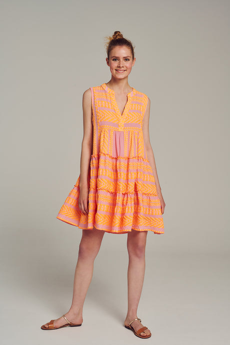 Sleeveless mini dress with pink and lime jacquard fabric, V-neck, and flared skirt.