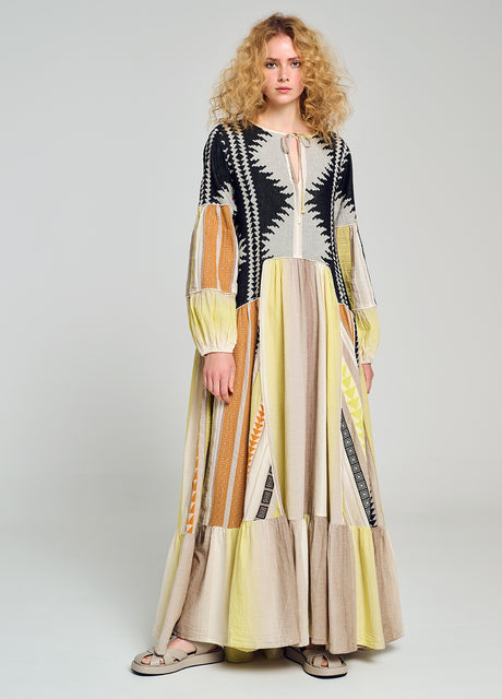 Long multicolor jacquard dress with geometric patterns, full sleeves, and tiered hem.