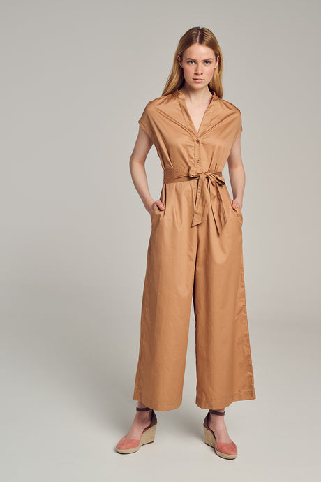 Beige sleeveless jumpsuit with wide legs, V-neckline, button front, and waist tie belt.