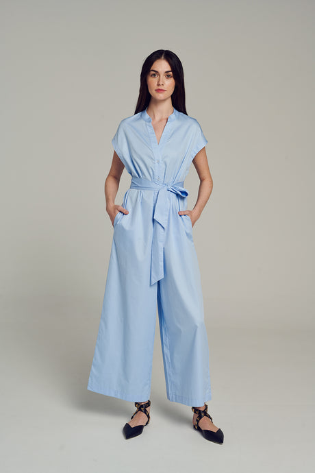 Light blue short-sleeve wide-leg jumpsuit with collar and waist tie belt.