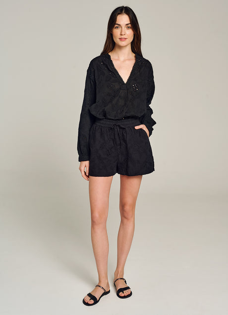 Black high-waist shorts with subtle floral embroidery and an elastic waistband with drawstring.