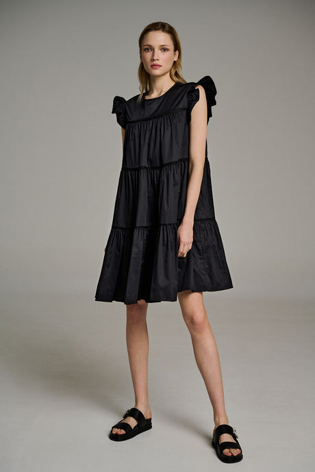 Black sleeveless tiered popeline dress with shoulder ties and square neckline.