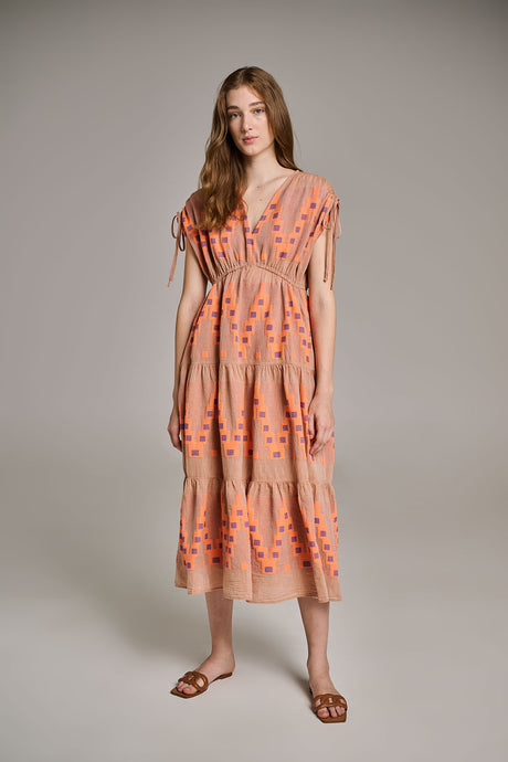 Midi beige jacquard dress with orange geometric print and short sleeves, styled with brown sandals.