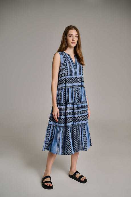 Sleeveless midi dress with black and blue geometric jacquard pattern, tiered skirt, and V-neckline.