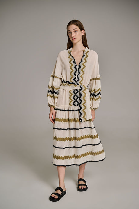 Off-white long jacquard dress with khaki zigzag stripes and balloon sleeves.