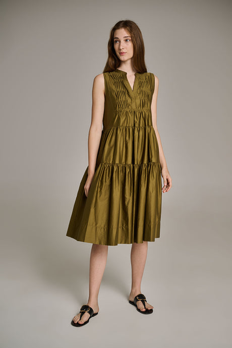 Sleeveless khaki midi dress with tiered skirt and V-neck worn with black sandals.