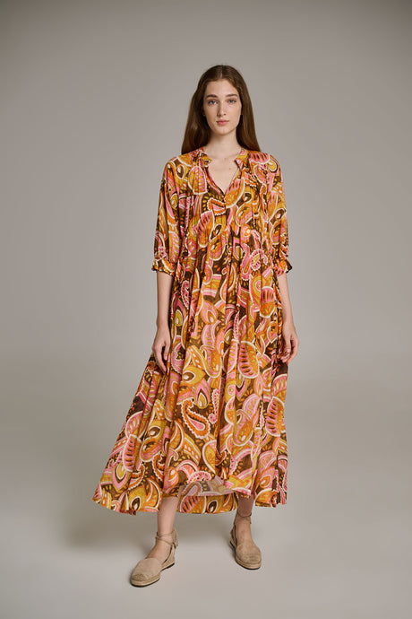 Pink and orange long flowy dress with abstract print and three-quarter sleeves.