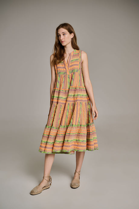 Sleeveless beige midi dress with orange jacquard stripes and tiered skirt, paired with tan shoes.