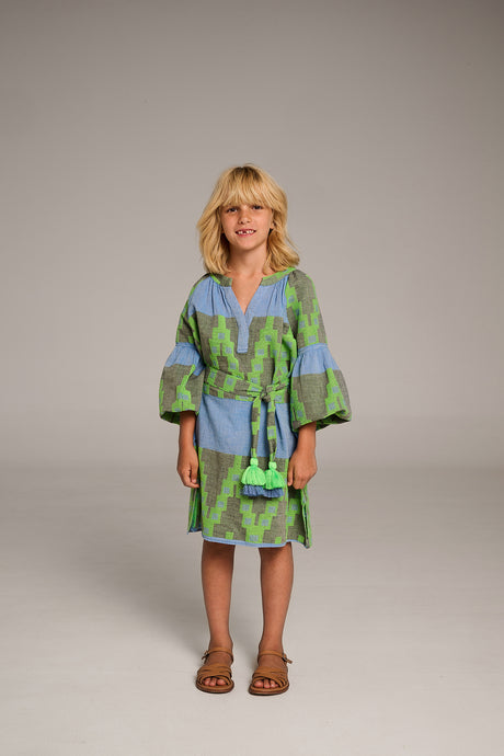 Blue and green patterned knee-length dress with wide sleeves and waist tie worn by woman.